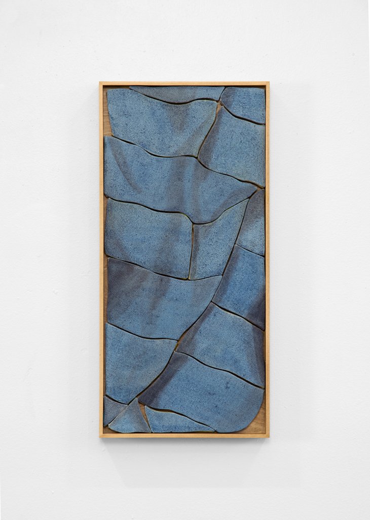 Artwork by Ryan Mrozowski featuring an interlocking puzzle-like composition. The piece plays with fragmented forms.